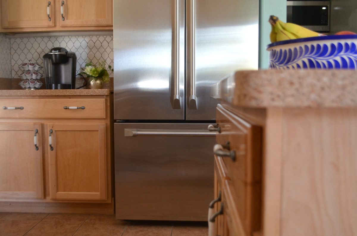 streak free shiny refrigerator in kitchen with brown cabinets