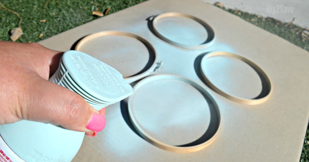DIY Farmhouse Style Decorative Orbs being spray painted