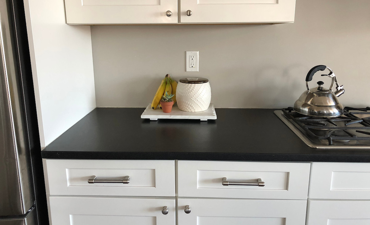 clean counter top with a bunch of bananas and a succulent on top