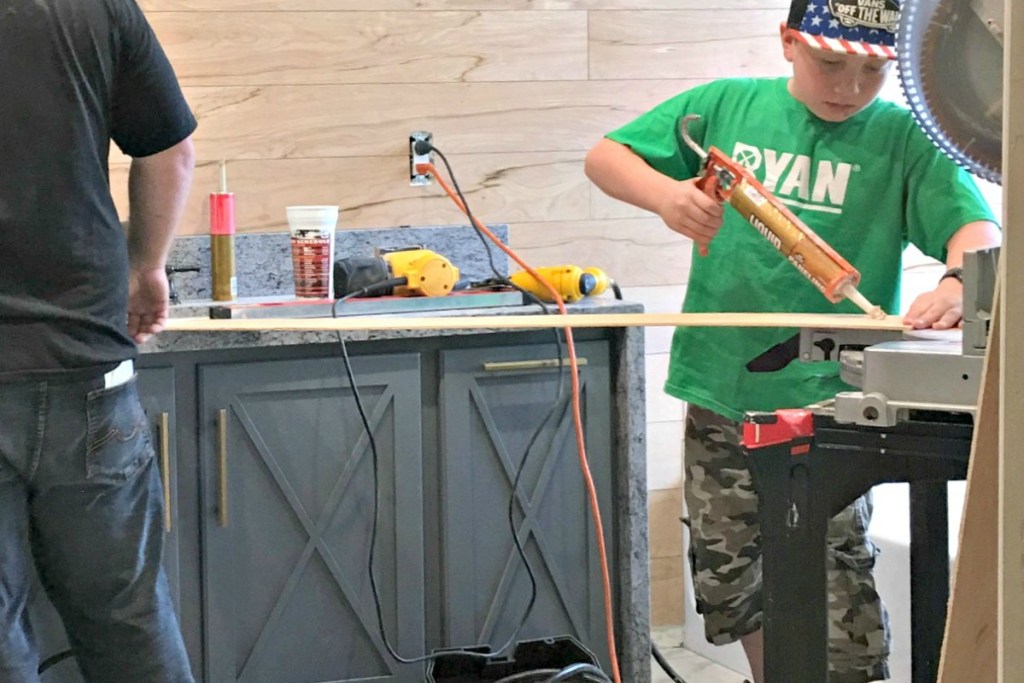 family putting up shiplap walls together 