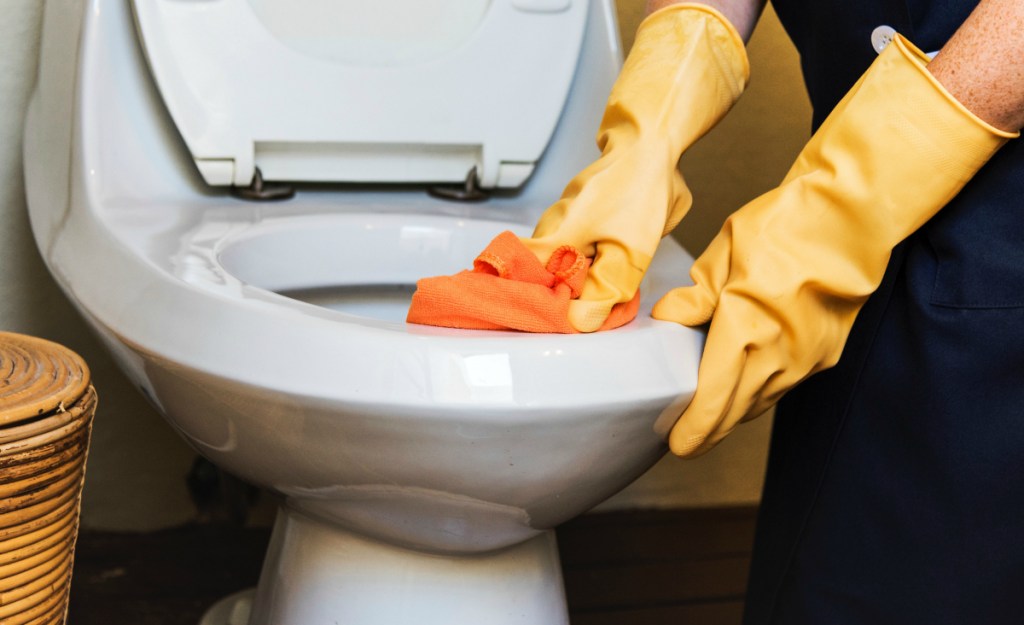 adult cleaning bathroom