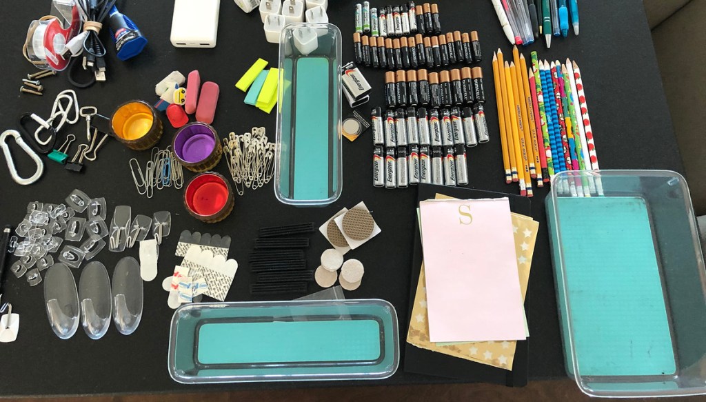 groups of stuff on counter with clear acrylic drawer organizers