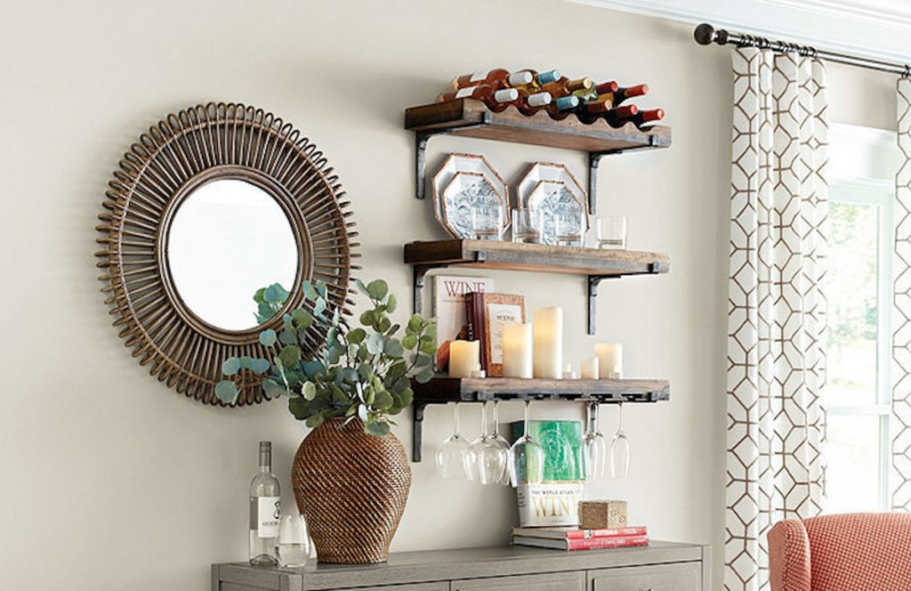 wood and iron shelves on wall next with mirror with other decor