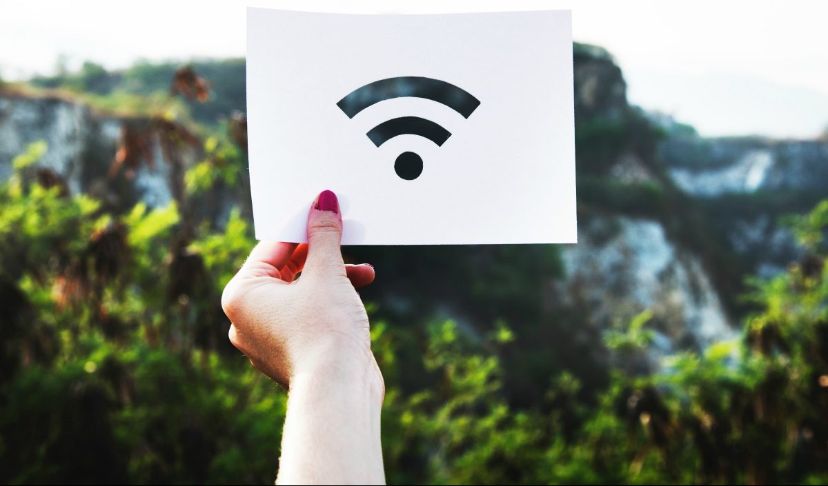 woman holding wi-fi signal poster