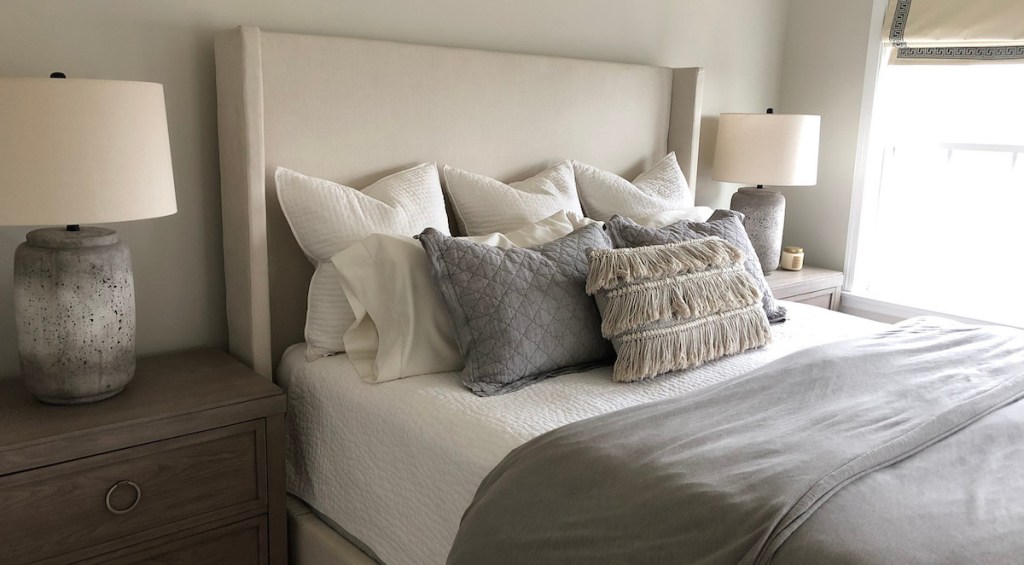 eight pillows on bed