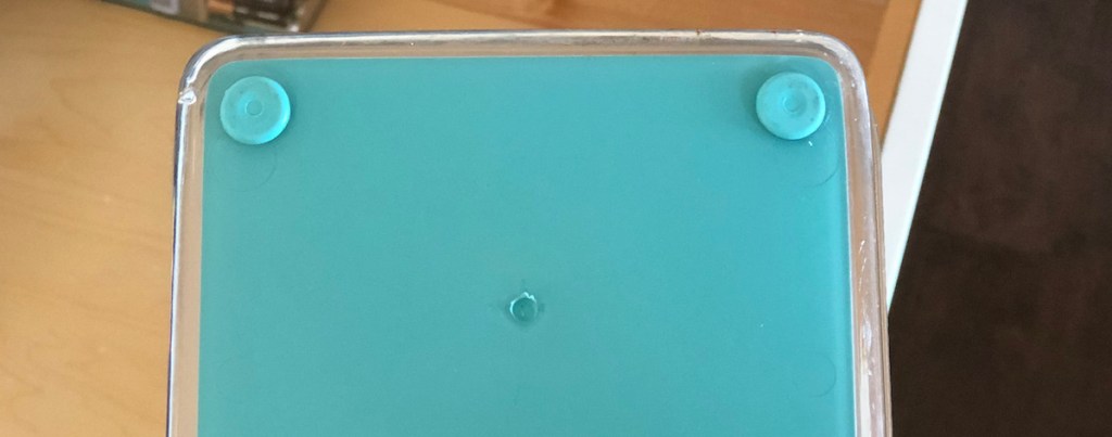 bottom of acrylic drawer organizer with blue rubber grips