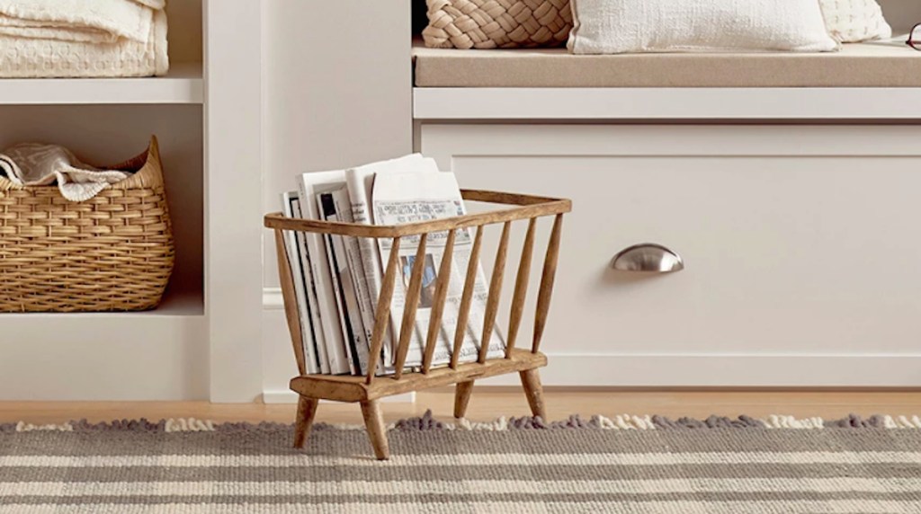wood magazine holder sitting on the floor in a house