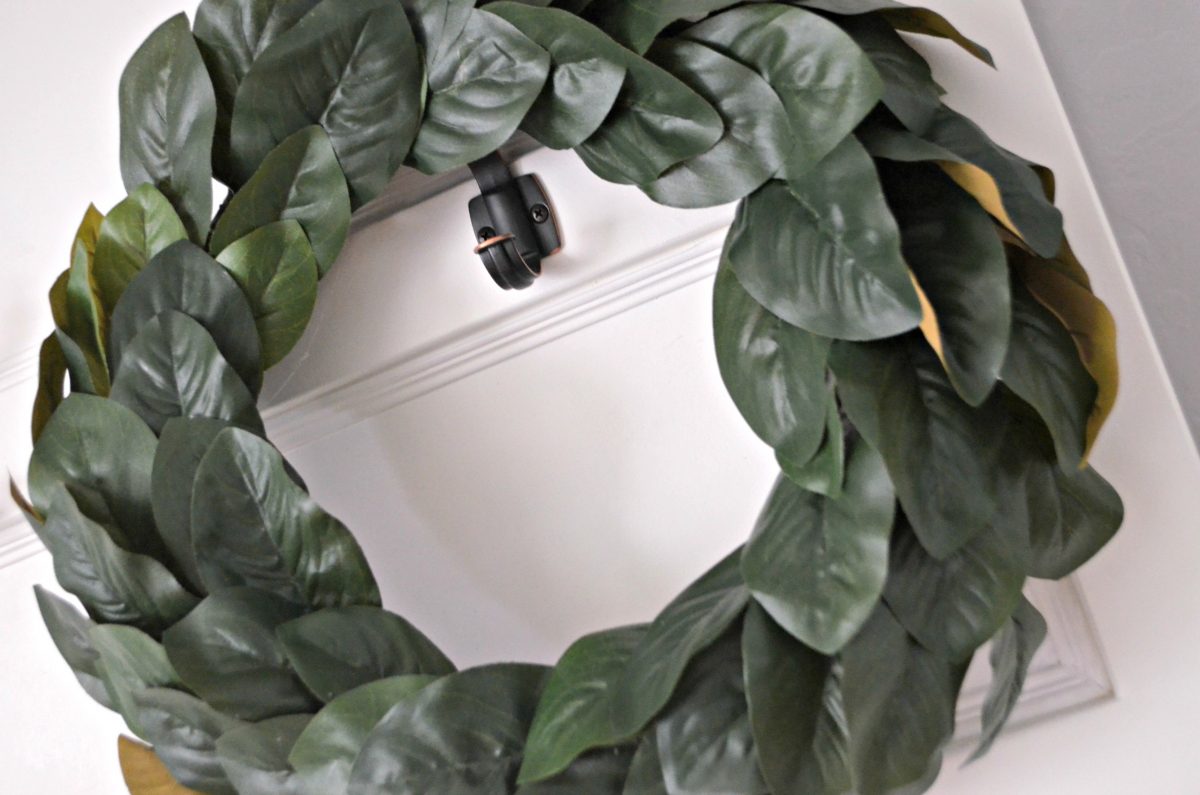 faux magnolia wreath on a front door