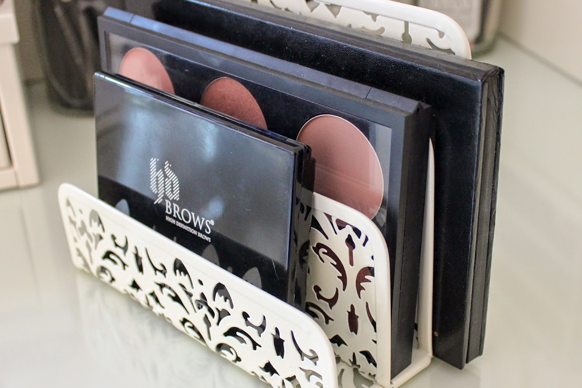 napkin holder being used as eye shadow palette organizer