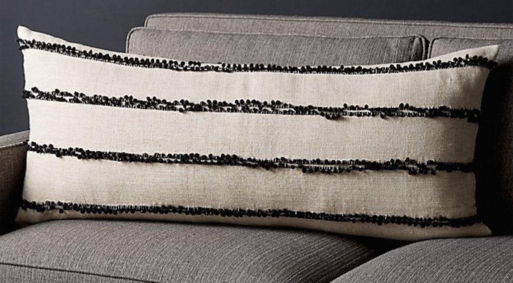 black and white stripe lumbar pillow on gray couch