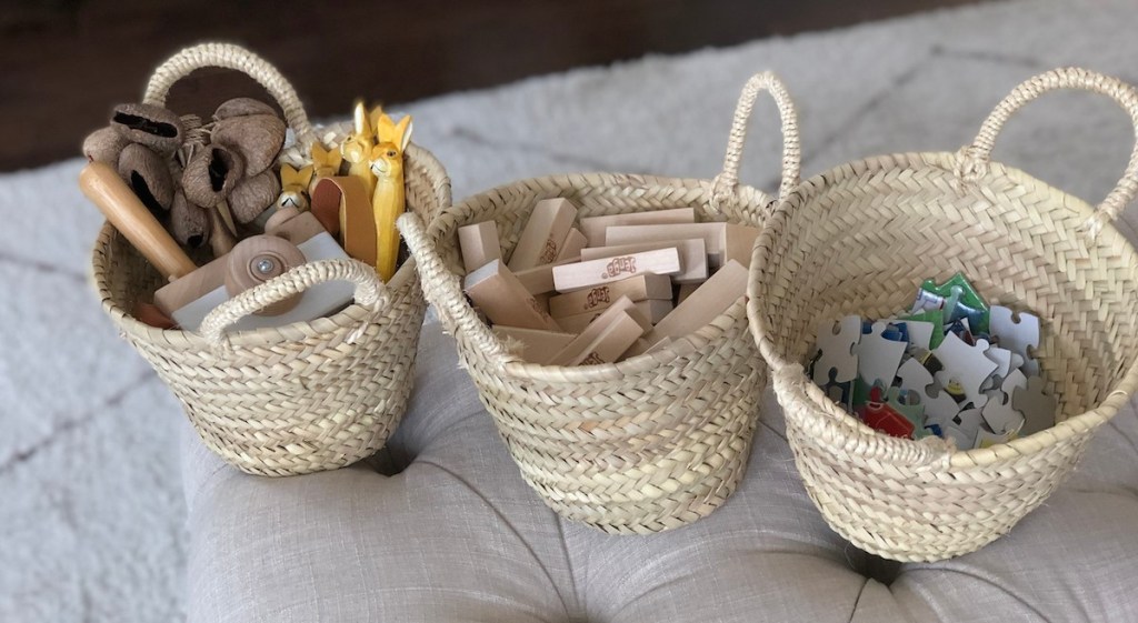 small toys puzzles and blocks in small seagrass baskets with handles
