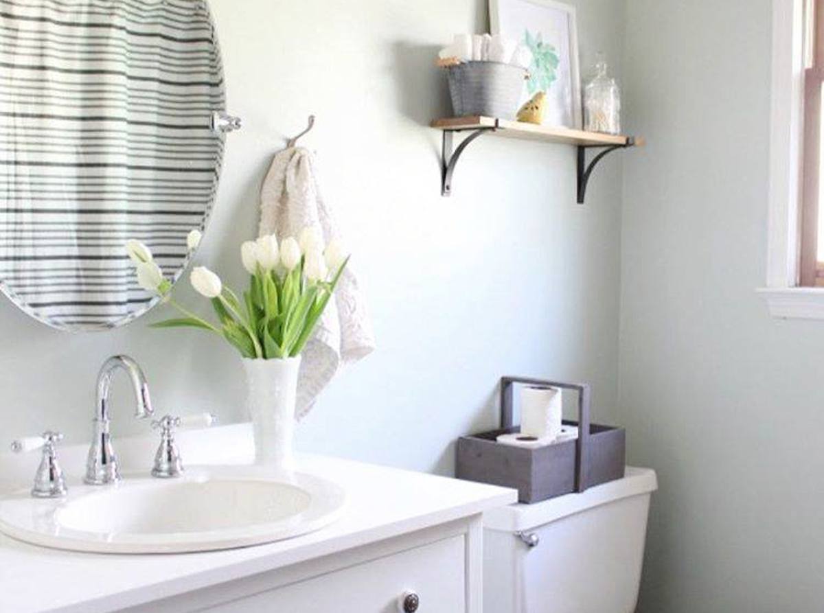 light and airy bathroom with fresh flowers on the sink
