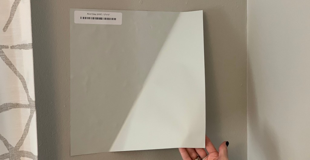 aloof gray paint sample being peeling off gray wall