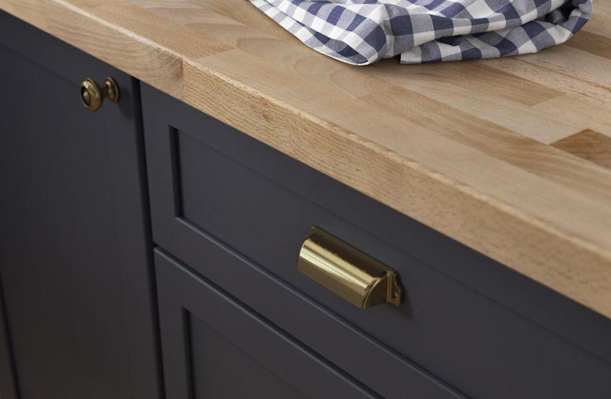 navy cabinet with brass cup pull hardware 