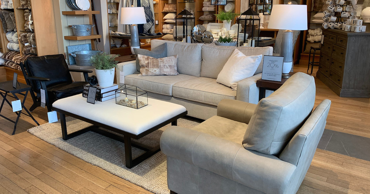 showroom with a gray couch and chair with black and white coffee table
