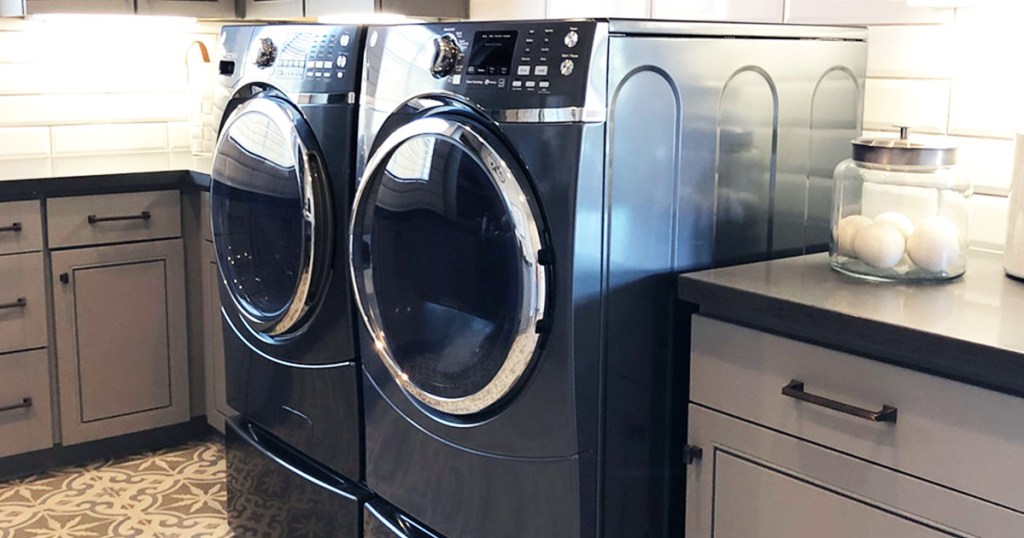 dark blue colored laundry room appliances with cabinets