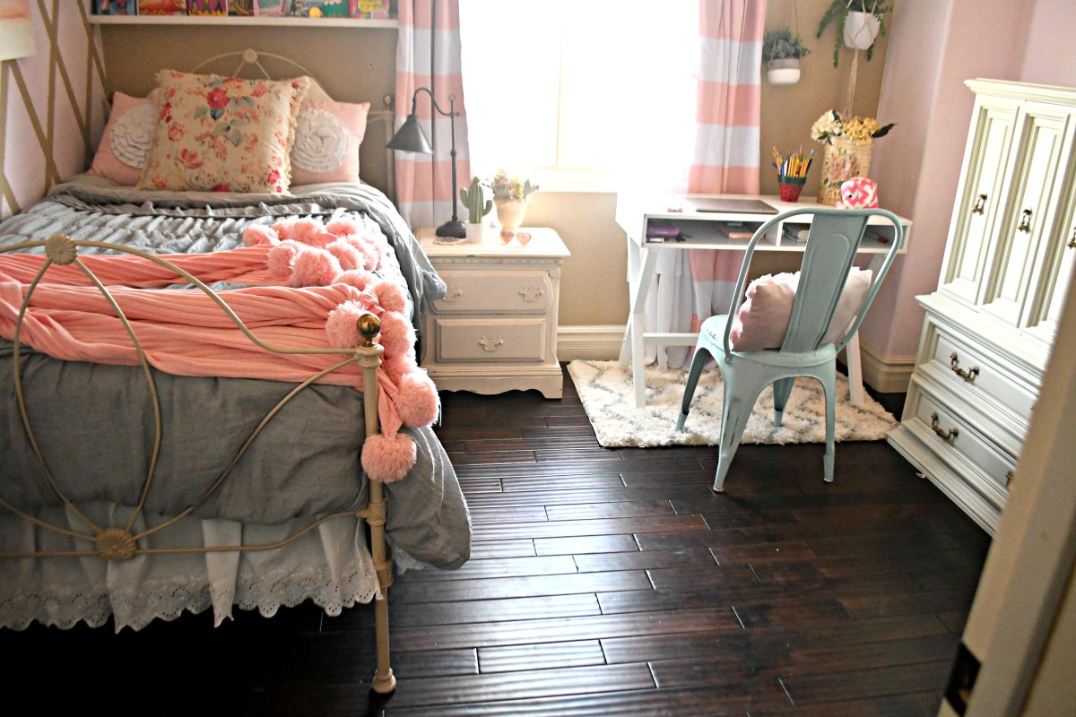 feminine bedroom with bed pink blanket and homework desk