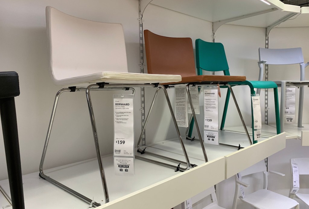 row of white brown blue chairs sitting on white store shelf