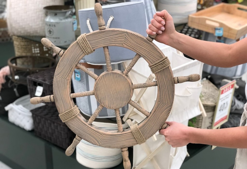 hands holding a steering wheel with baskets in the background