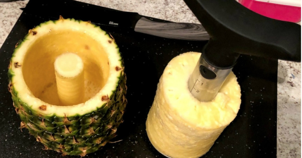 cool kitchen gadgets - cored pineapple sitting on black cutting board 