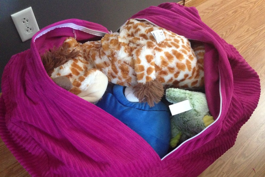 pink purple bean bag chair filled with various stuffed animals