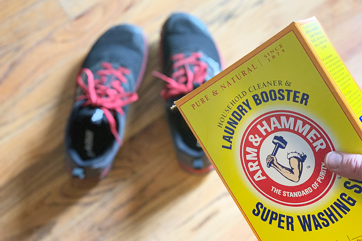 a box of washing soda being poured into sneakers