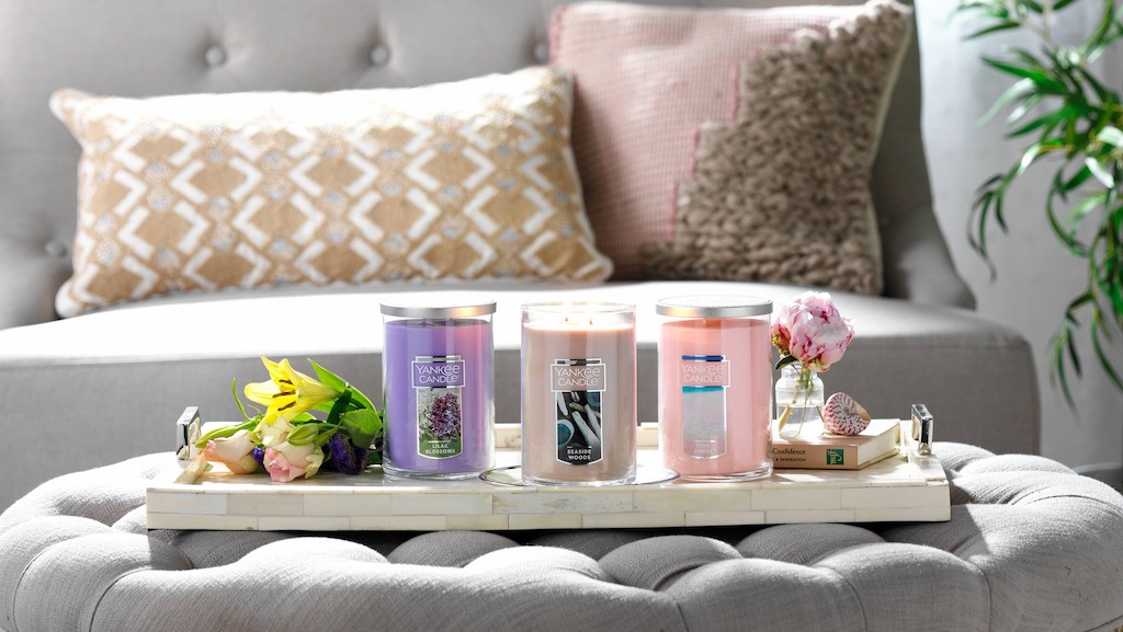 Yankee Candles sitting on ottoman in living room 