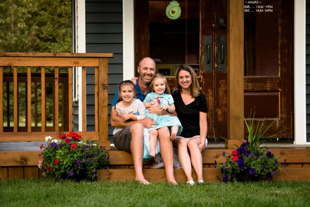 Adam Boyd family sitting on front porch