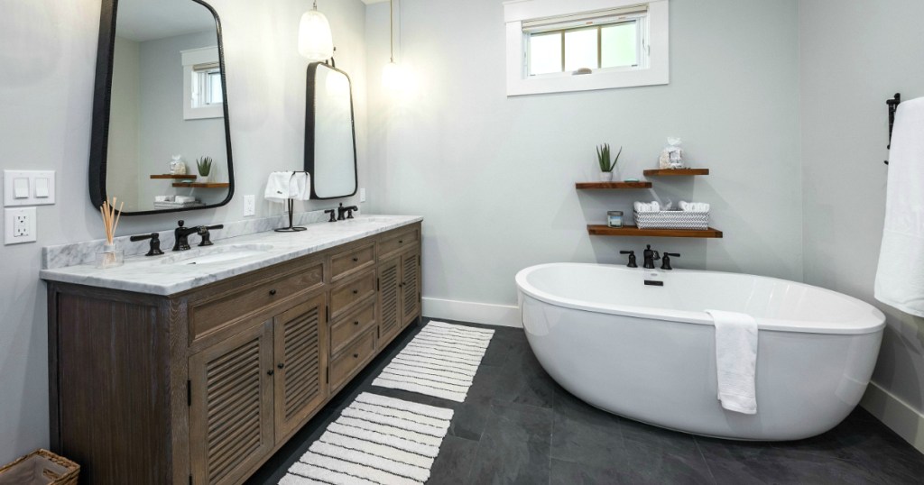 bathroom with bathtub, bathmats, counter