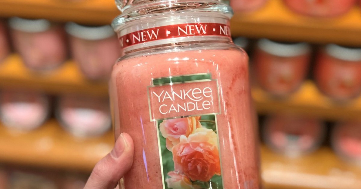 holding large jar Yankee Candle