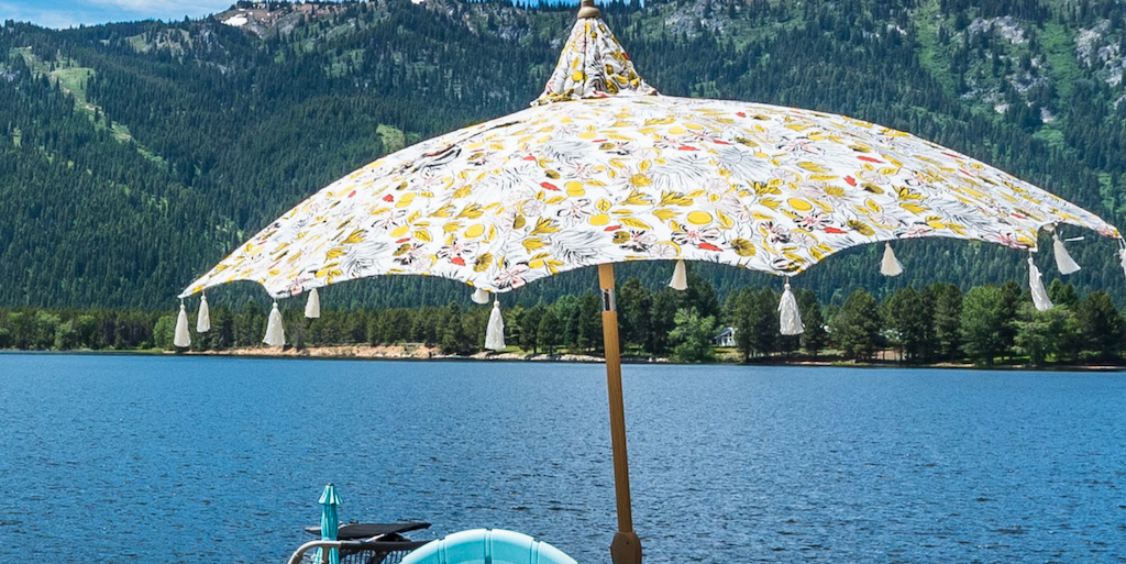 Opalhouse floral patio umbrella with lake in the background 