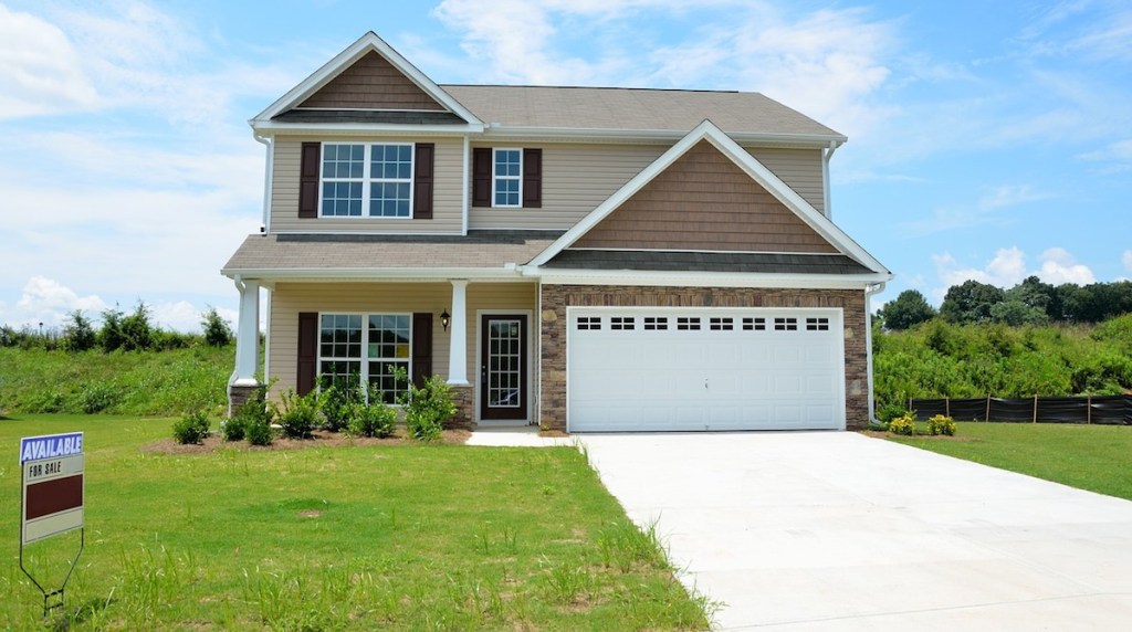 foreclosure sale house with overgrown grass