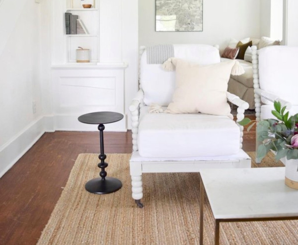 white accent chair with black side table