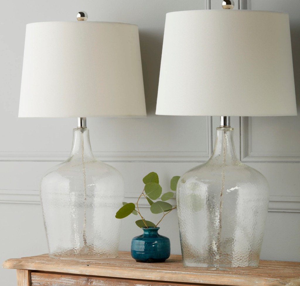 two glass table lamps with white lamp shades
