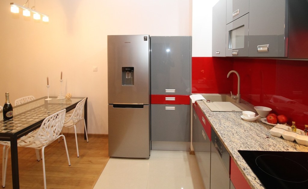 kitchen with red glossy backsplash and gray cabinets