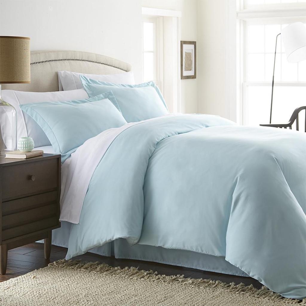 bedroom with solid cover duvet on bed 