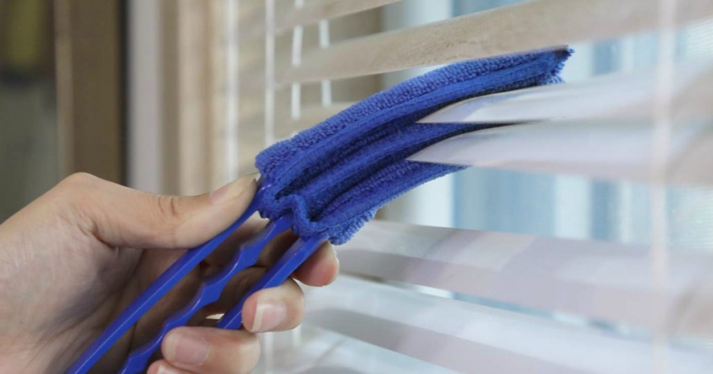 Using a blind duster on dirty blinds 