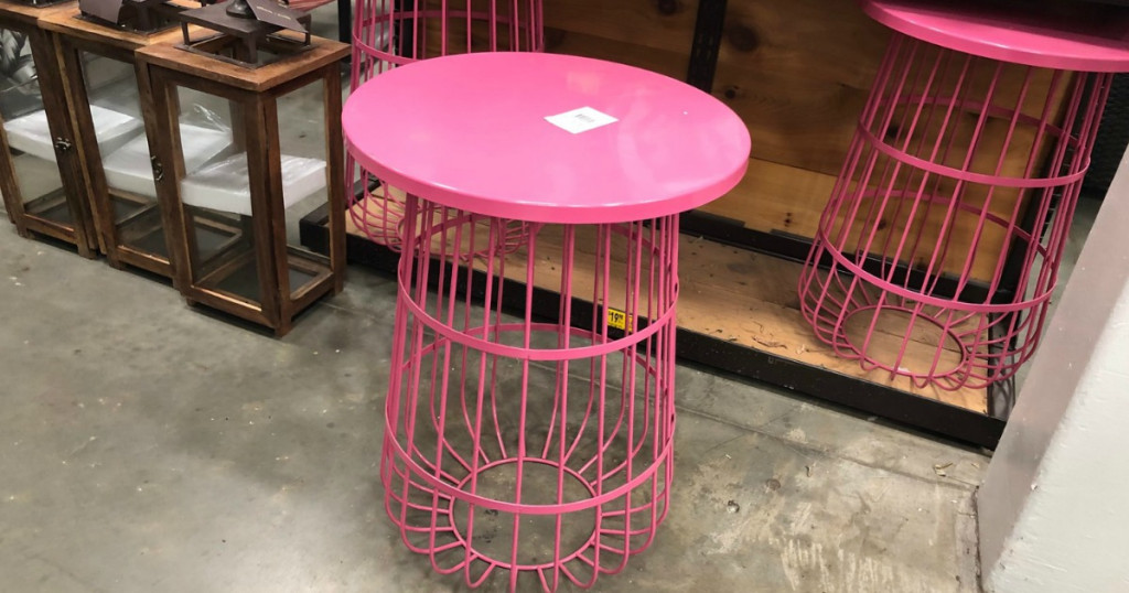 Pink wire plant stand sitting on the floor