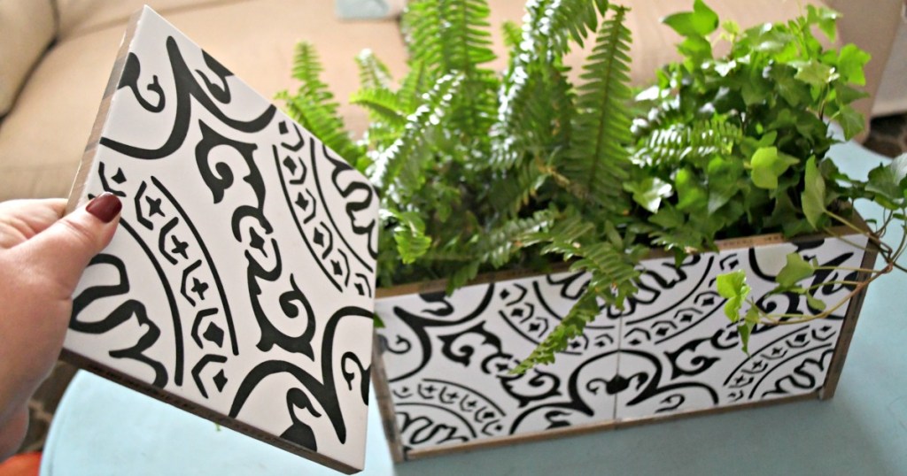 holding a tile to make a diy planter 