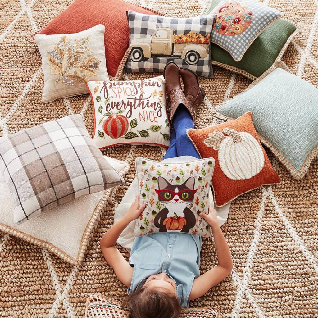 halloween and fall pillows on area rug 