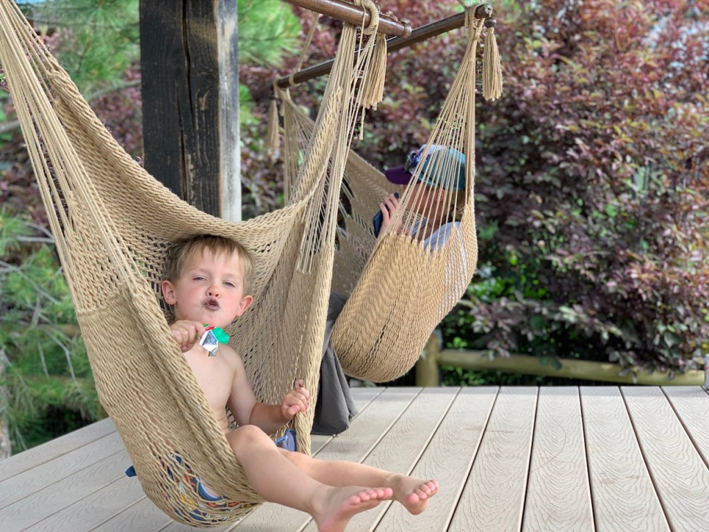 kid and mom sitting in hammock swings 