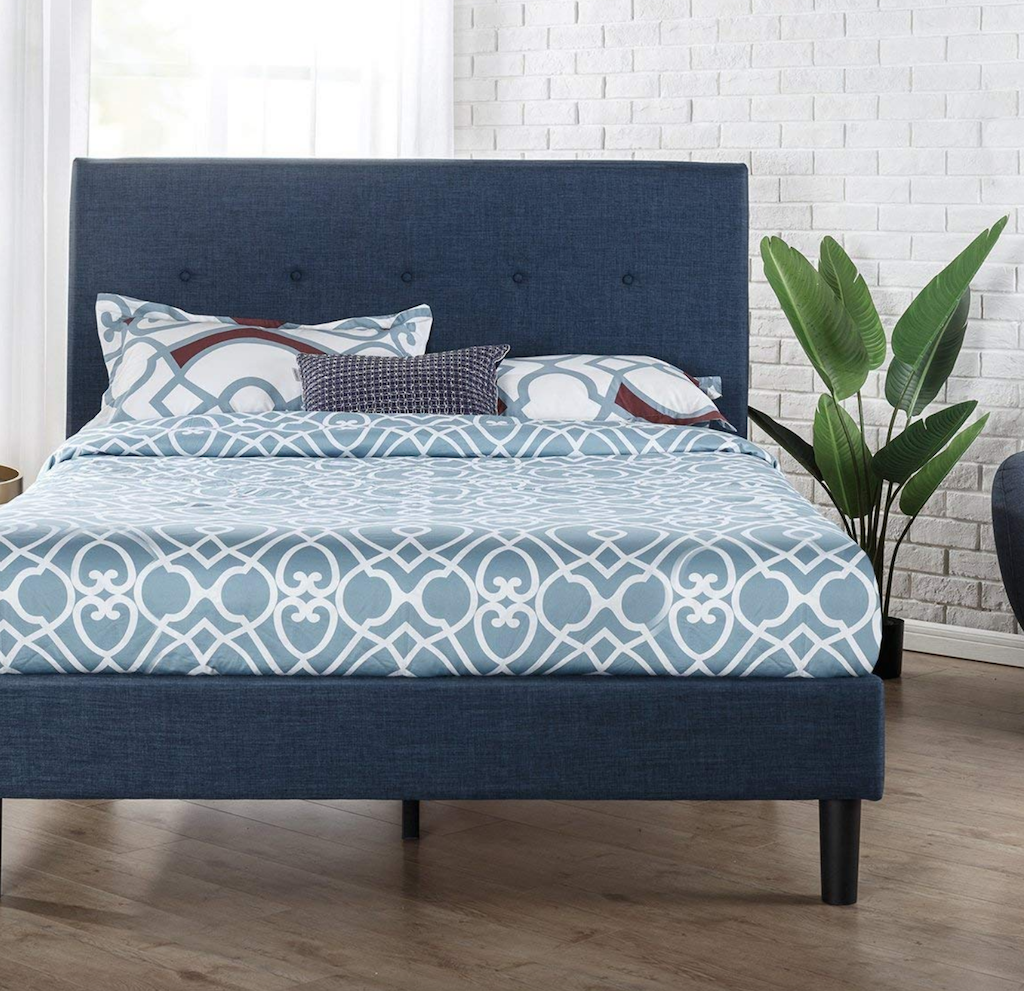 navy platform bed with pillows and bedding 