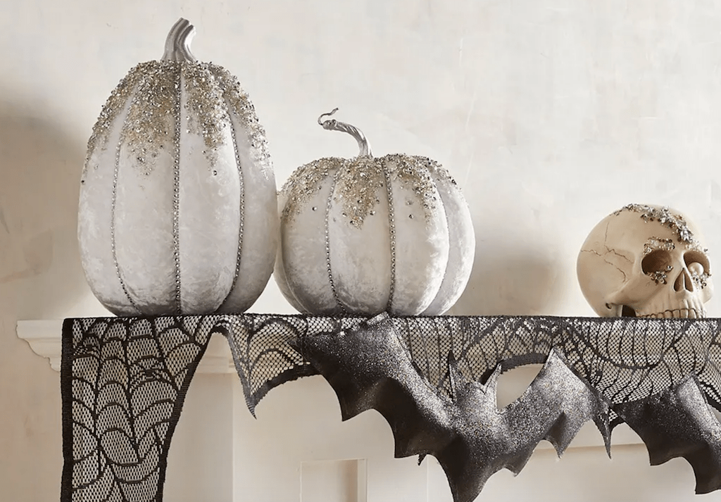 sparkle pumpkins on mantle with skull 