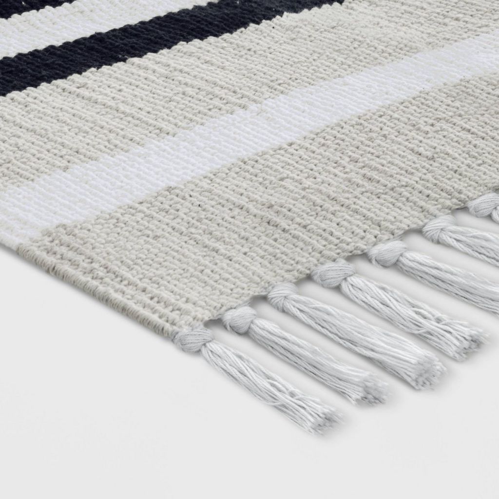 close up of striped woven accent rug