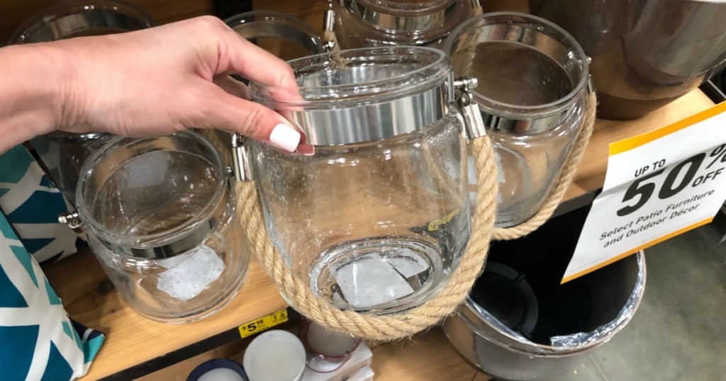 holding glass lantern at Lowe's 