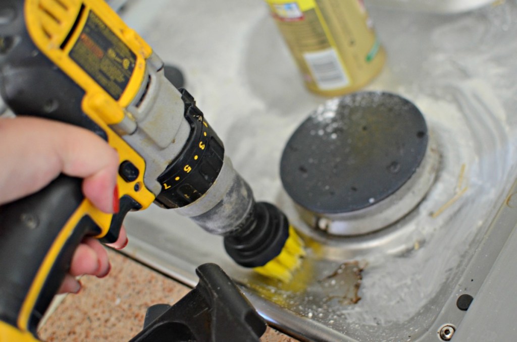 srubbing kitchen stove with drillbrush