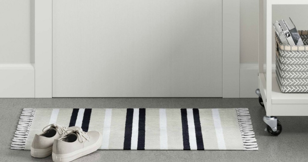 striped woven accent rug with shoes 