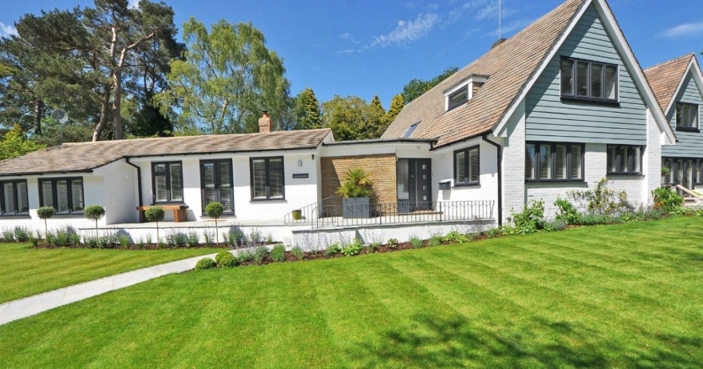 white brick house with green grass