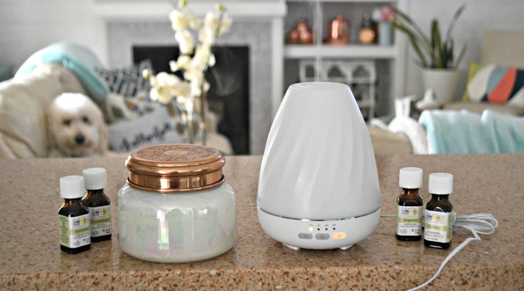 anthropologie candle and white diffuser sitting on countertop