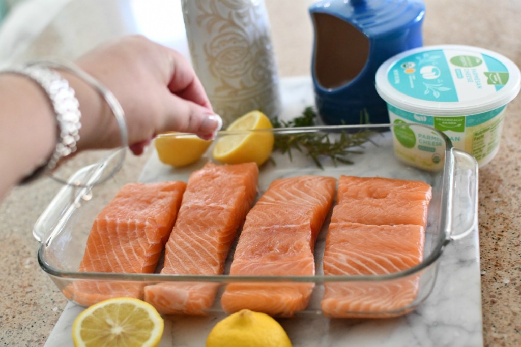 sprinkling salt on salmon before cooking 